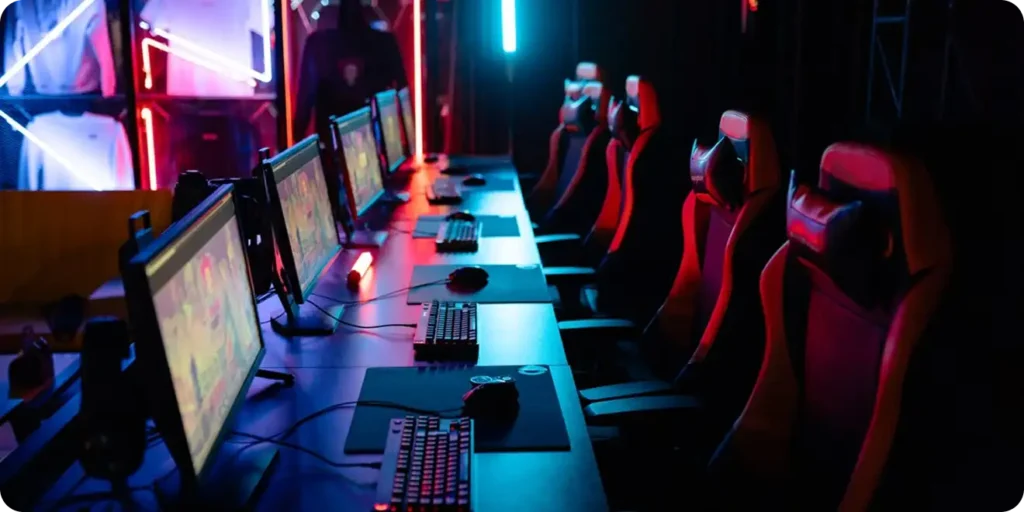 Professional esports arena with high-performance gaming computers and RGB gaming chairs.