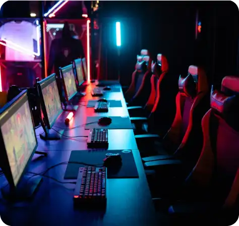 Professional esports arena with high-performance gaming computers and RGB gaming chairs.